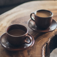 Two cups of coffee on a wood table